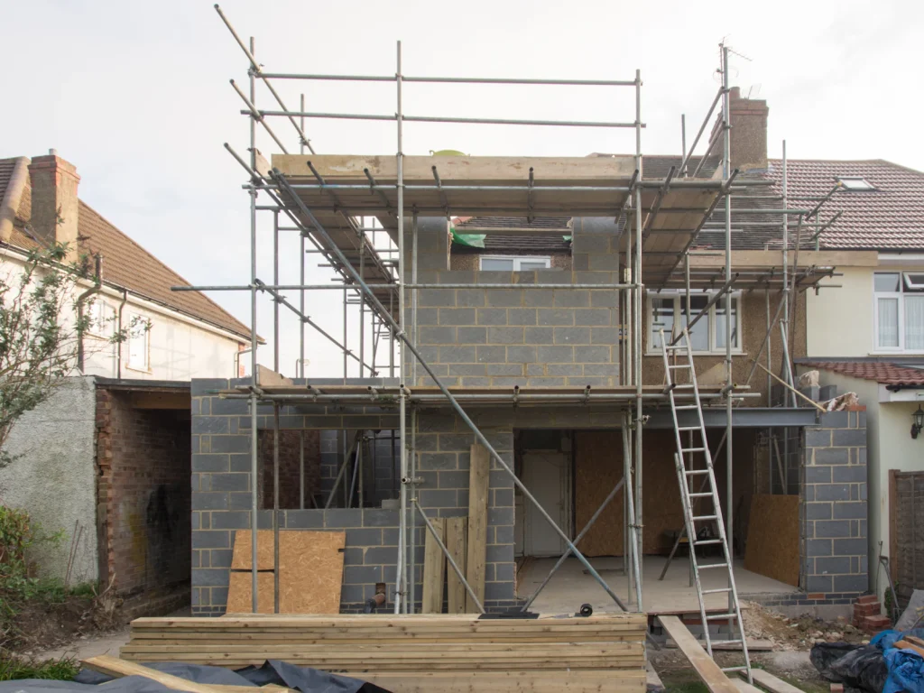 House extension under construction with scaffolding