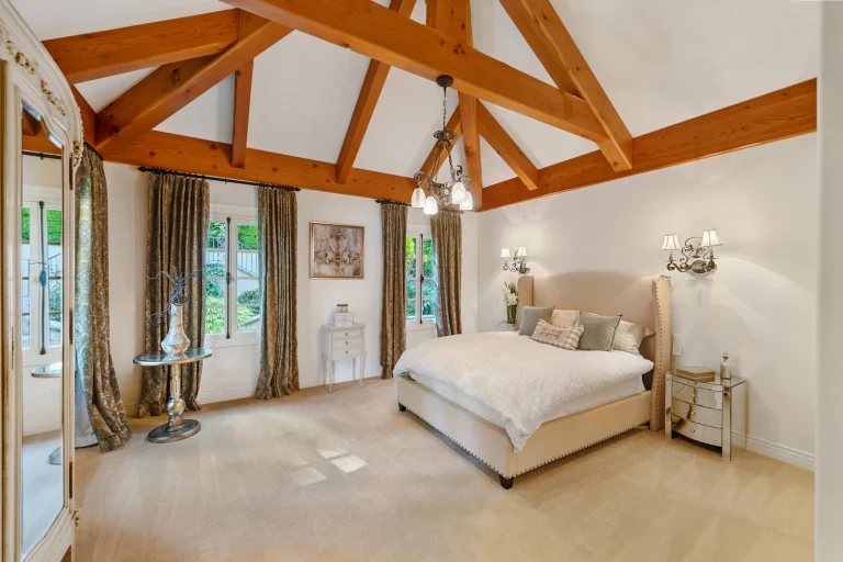 Loft bedroom with exposed timber trusses